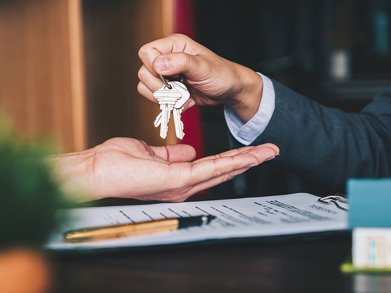 Real estate agent giving keys
